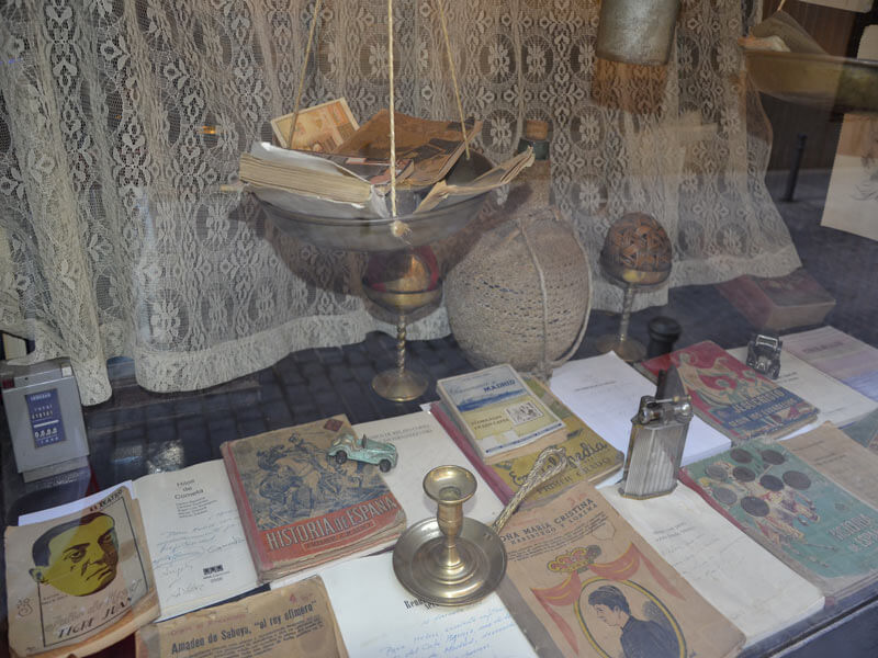 Mostrador de Café Ajenjo con libros y objetos de coleccionista de principios del siglo XX